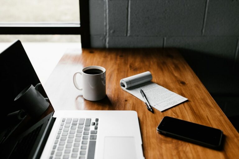 Person working on a laptop at a desk, building an online income through affiliate marketing